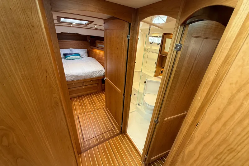 Slide: The Image of Luxurious interior of 2026 Sabre 45 Salon Express yacht, featuring wood finishes and cozy bedroom. - 30