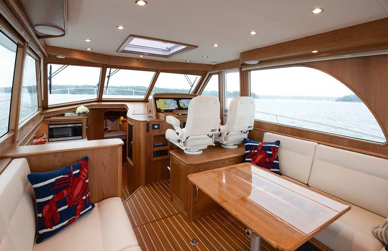 Slide: The Image of Interior of 2026 Sabre 45 Salon Express yacht with elegant seating and navigation area. - 6