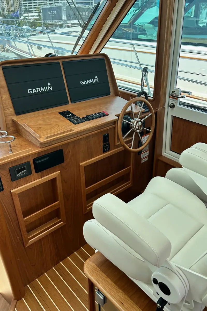 Slide: The Image of 2026 Sabre 45 Salon Express helm with Garmin displays and luxurious seating. - 8