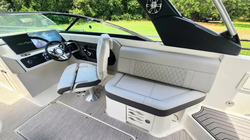 Slide: The Image of 2021 Sea Ray SLX 250 boat interior with modern helm and comfortable seating. - 14