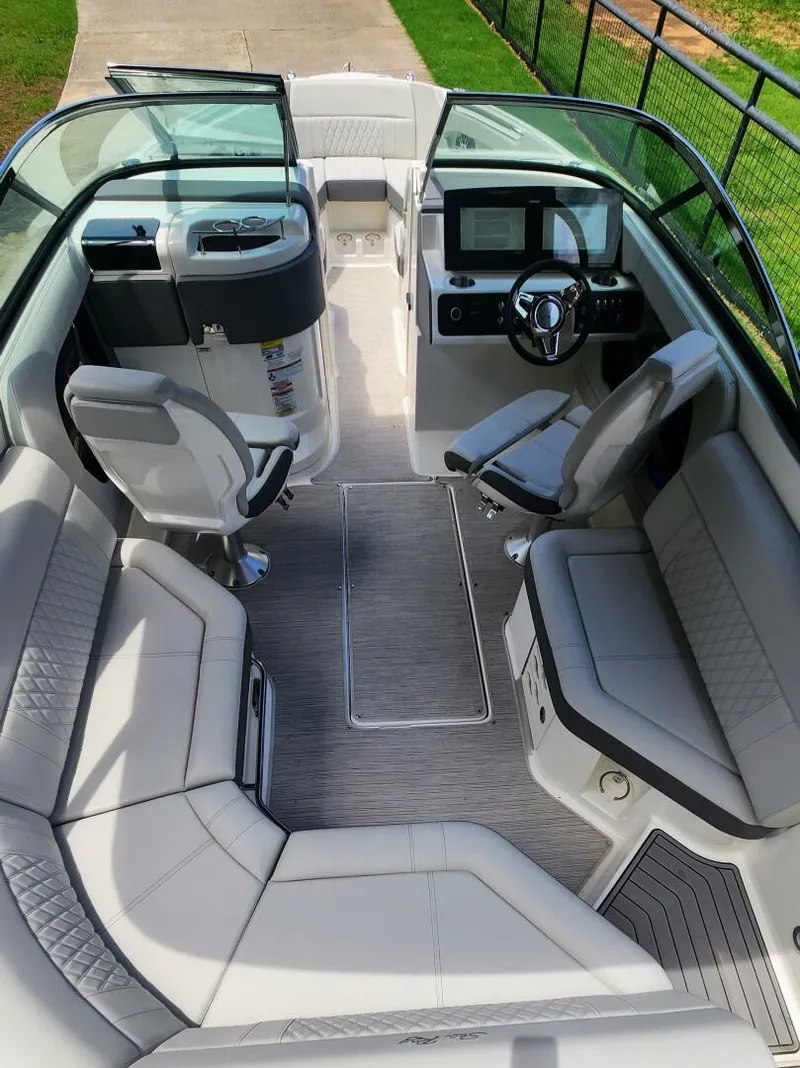 Slide: The Image of 2021 Sea Ray SLX 250 boat interior with luxurious seating and modern dashboard. - 16