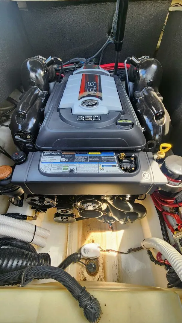 Slide: The Image of 2021 Sea Ray SLX 250 engine compartment featuring a powerful MerCruiser 6.2L engine. - 19