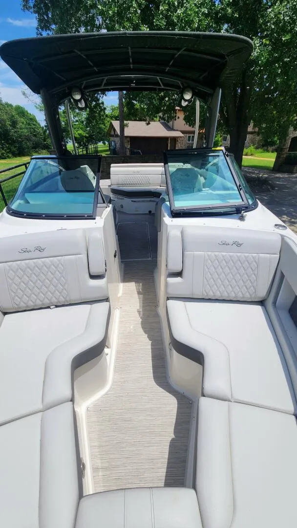 Slide: The Image of 2021 Sea Ray SLX 250 boat interior with luxurious seating and open deck design. - 21