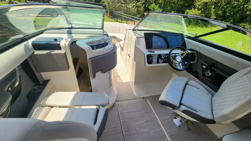 Slide: The Image of 2021 Sea Ray SLX 250 boat interior with modern dashboard and luxurious seating. - 26