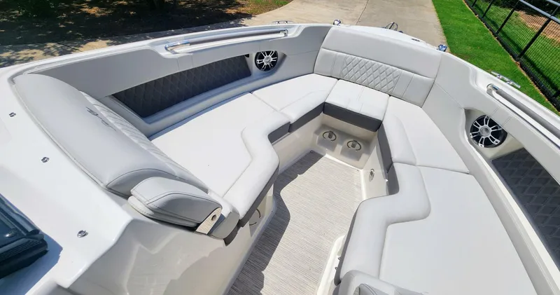 Slide: The Image of Luxurious seating area on a 2021 Sea Ray SLX 250 boat, featuring elegant upholstery. - 29