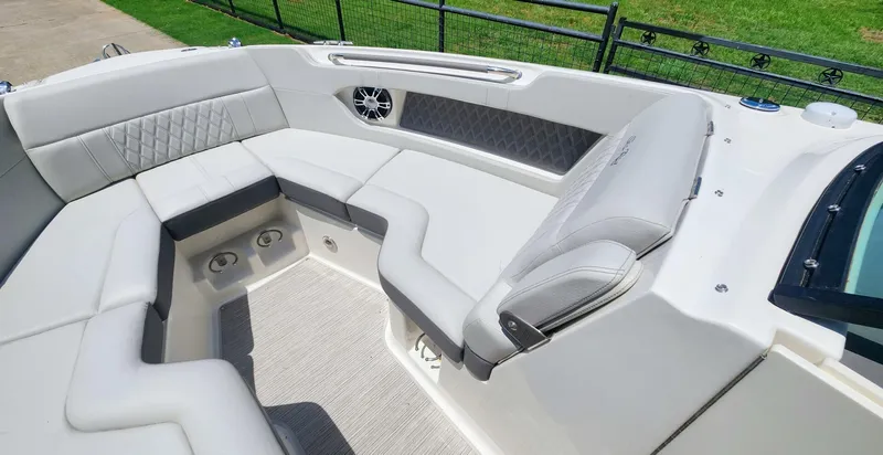 Slide: The Image of Luxurious seating area on a 2021 Sea Ray SLX 250 boat, featuring elegant upholstery. - 30