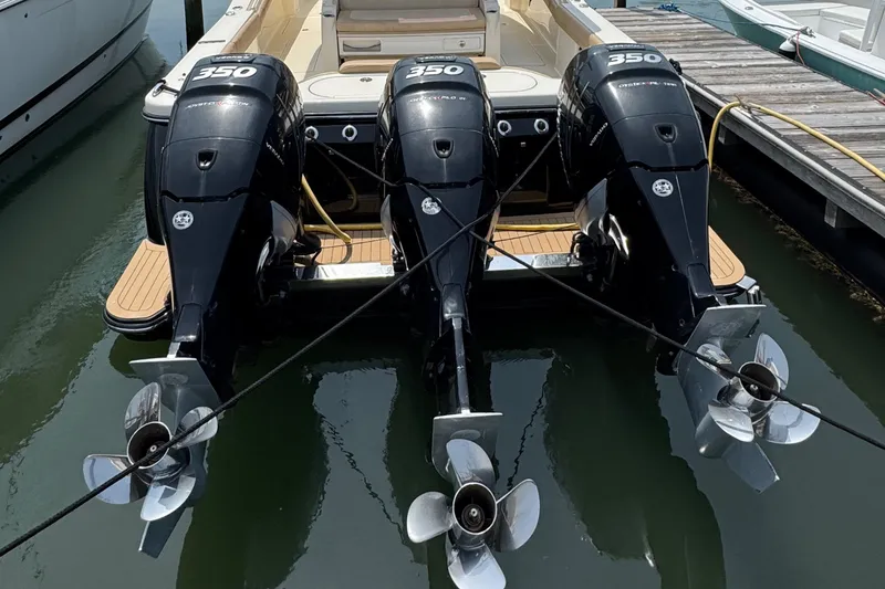 Slide: The Image of 2018 Scout 380 LXF boat with triple 350 horsepower outboard engines docked at marina. - 18