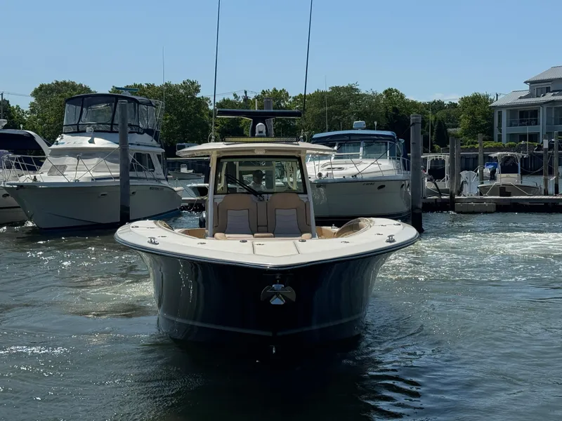 Slide: The Image of 2018 Scout 380 LXF boat docked at marina, surrounded by other vessels. - 5