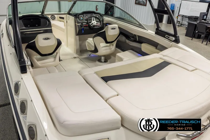 Slide: The Image of 2016 Chaparral 216 SSi boat interior with beige seating and modern dashboard. - 10