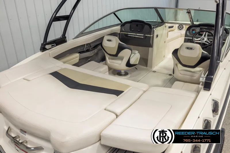Slide: The Image of 2016 Chaparral 216 SSi boat interior with beige seating and modern dashboard. - 11