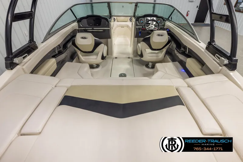 Slide: The Image of Interior of a 2016 Chaparral 216 SSi boat with beige seating and modern dashboard. - 12
