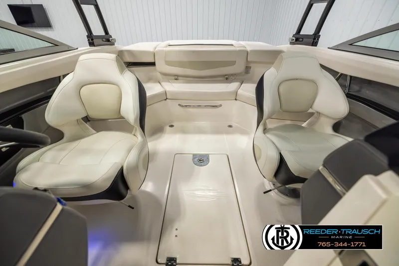 Slide: The Image of Interior of a 2016 Chaparral 216 SSi boat with white seating and modern design. - 17
