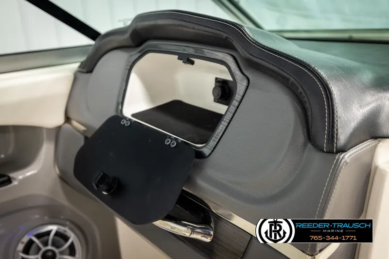 Slide: The Image of 2016 Chaparral 216 SSi boat dashboard with open glove compartment and speaker. - 22