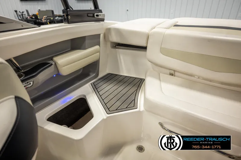 Slide: The Image of Interior of 2016 Chaparral 216 SSi boat, featuring seating and storage compartments. - 26