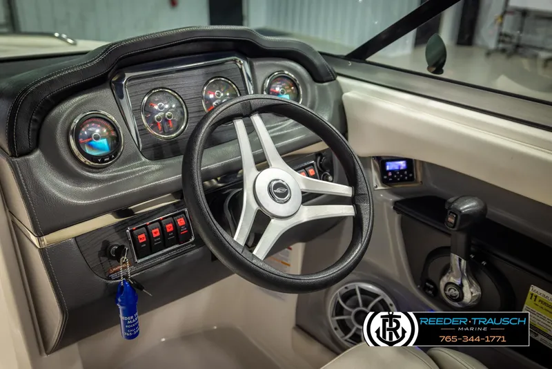 Slide: The Image of 2016 Chaparral 216 SSi boat dashboard with steering wheel and control panel. - 28