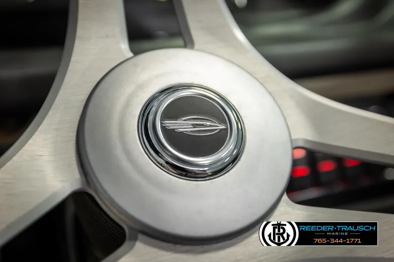Slide: The Image of Steering wheel of 2016 Chaparral 216 SSi boat, featuring logo and Reeder-Trausch Marine branding. - 29