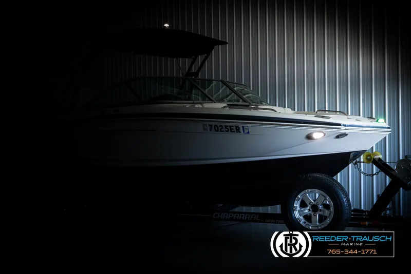 Slide: The Image of 2016 Chaparral 216 SSi boat in dimly lit storage, side view. - 3