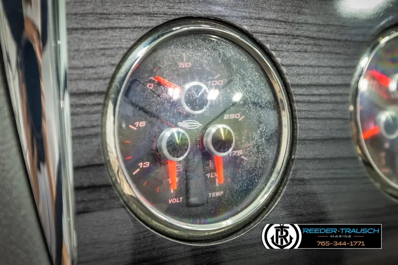 Slide: The Image of Dashboard gauges of a 2016 Chaparral 216 SSi boat, featuring volt and temperature indicators. - 32