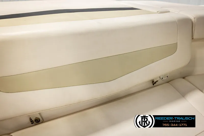 Slide: The Image of 2016 Chaparral 216 SSi boat interior seating, featuring cream and beige upholstery. - 39