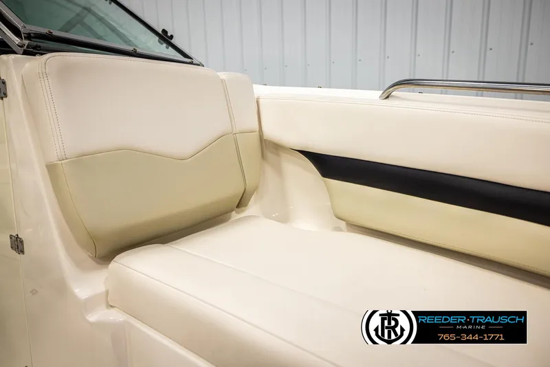 Slide: The Image of 2016 Chaparral 216 SSi boat interior with beige seating and black accent. - 40