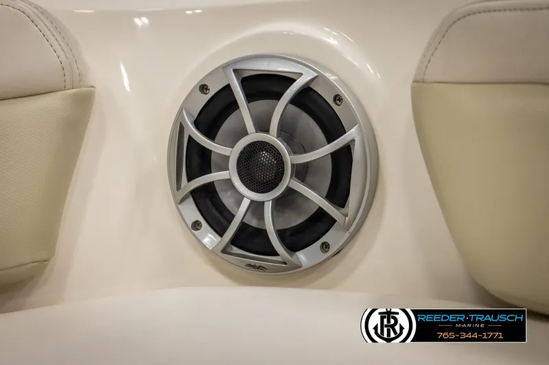 Slide: The Image of Speaker on 2016 Chaparral 216 SSi boat interior, featuring beige upholstery. - 41