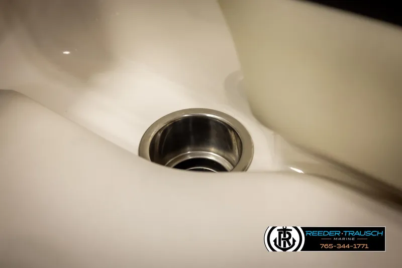 Slide: The Image of Close-up of a Chaparral 216 SSi 2016 boat drain with Reeder-Trausch Marine logo. - 42