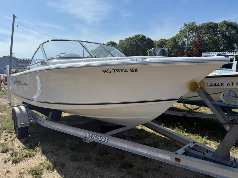 The Image of 2012 Sea Hunt Escape 188LE boat on trailer, parked outdoors. - 0