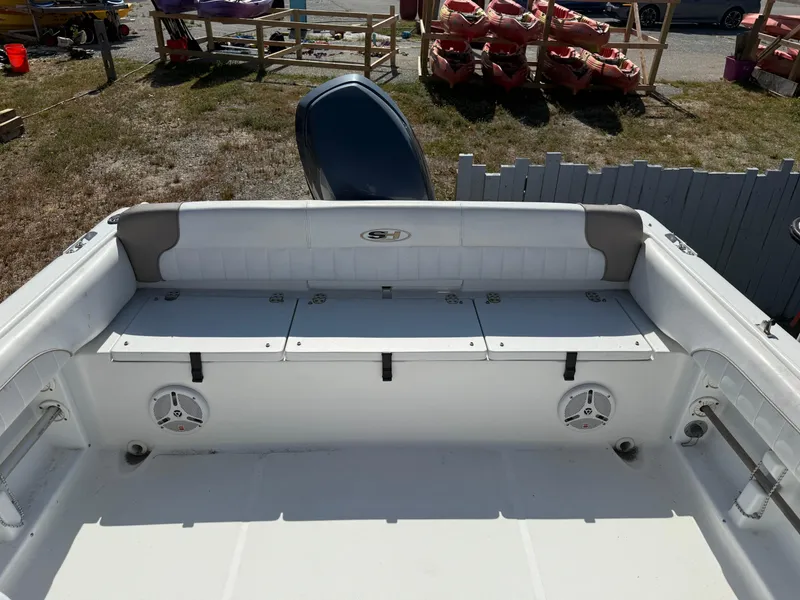 Slide: The Image of 2012 Sea Hunt Escape 188LE boat interior with seating and storage compartments. - 10