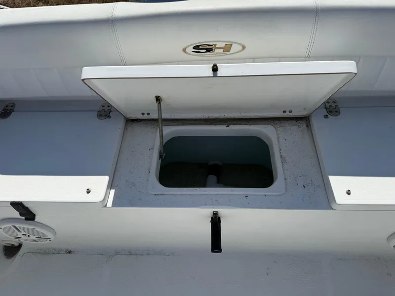 Slide: The Image of 2012 Sea Hunt Escape 188LE boat storage compartment with open lid. - 11