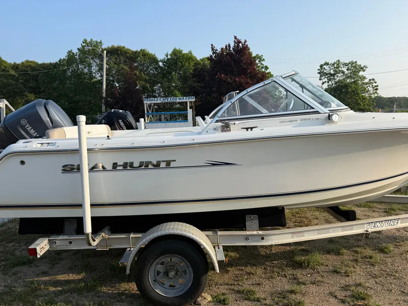 Slide: The Image of 2012 Sea Hunt Escape 188LE boat on trailer, side view, outdoors. - 14