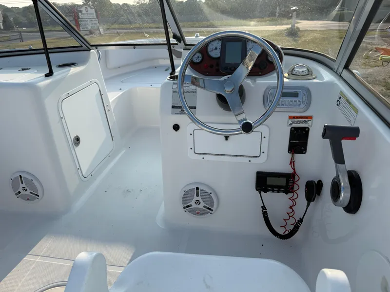 Slide: The Image of 2012 Sea Hunt Escape 188LE boat interior with steering wheel and control panel. - 8