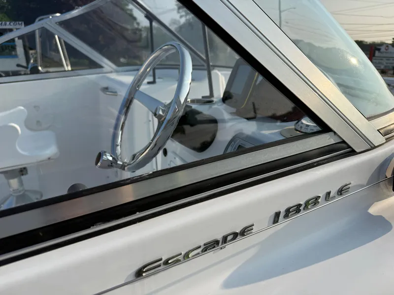 Slide: The Image of 2012 Sea Hunt Escape 188LE boat interior with steering wheel and model name. - 9