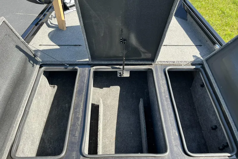 Slide: The Image of 2022 Alumacraft Pro 175 boat storage compartments open, showcasing ample space. - 14