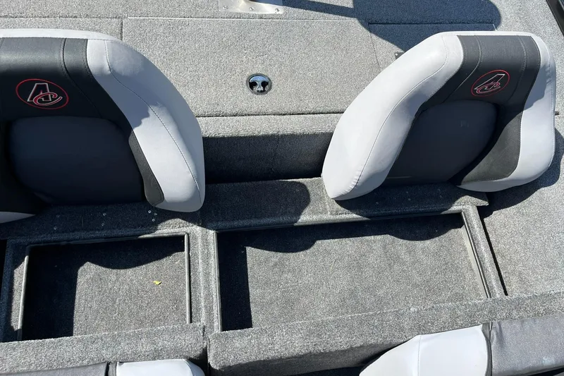Slide: The Image of 2022 Alumacraft Pro 175 boat interior with gray seating and storage compartments. - 16