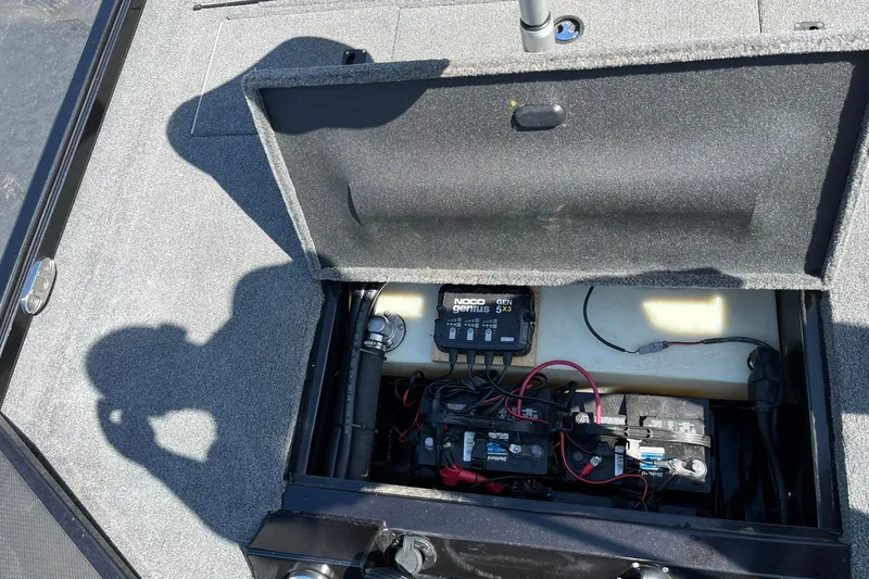 Slide: The Image of 2022 Alumacraft Pro 175 boat battery compartment with NOCO Genius charger and wiring. - 19
