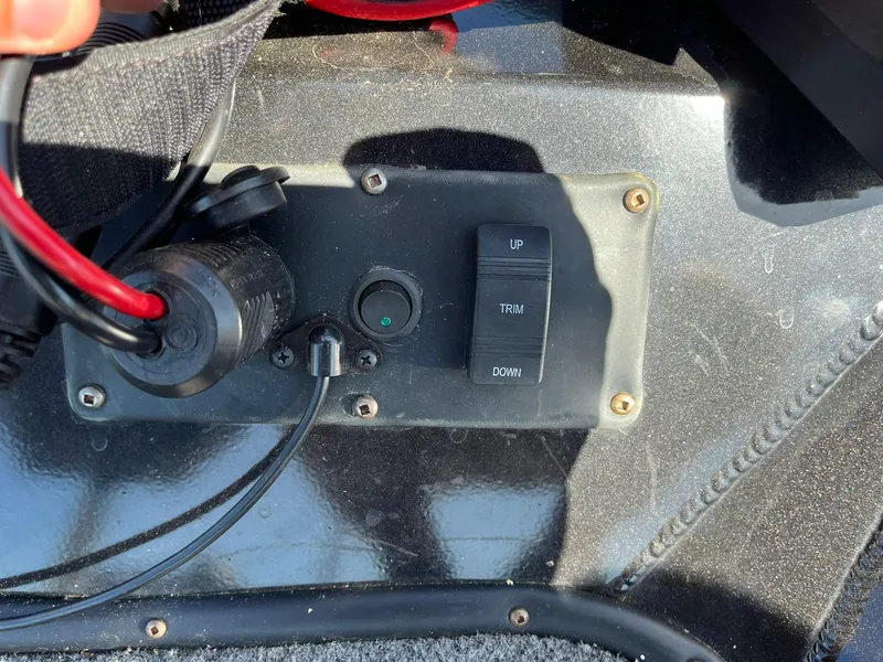 Slide: The Image of Control panel of a 2022 Alumacraft Pro 175 boat with trim switch and wiring. - 22