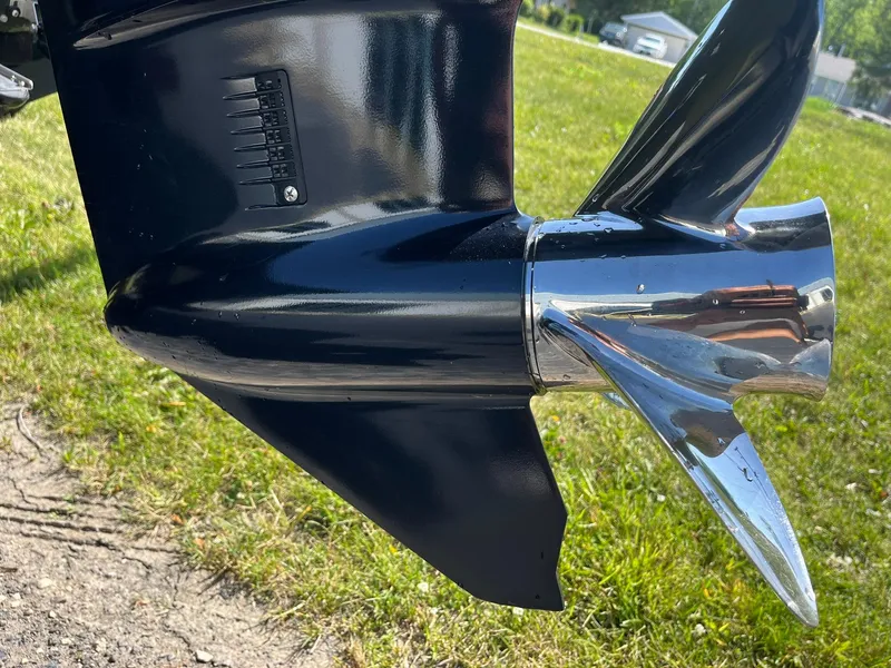 Slide: The Image of 2022 Alumacraft Pro 175 boat propeller, shiny chrome finish, on grassy background. - 28
