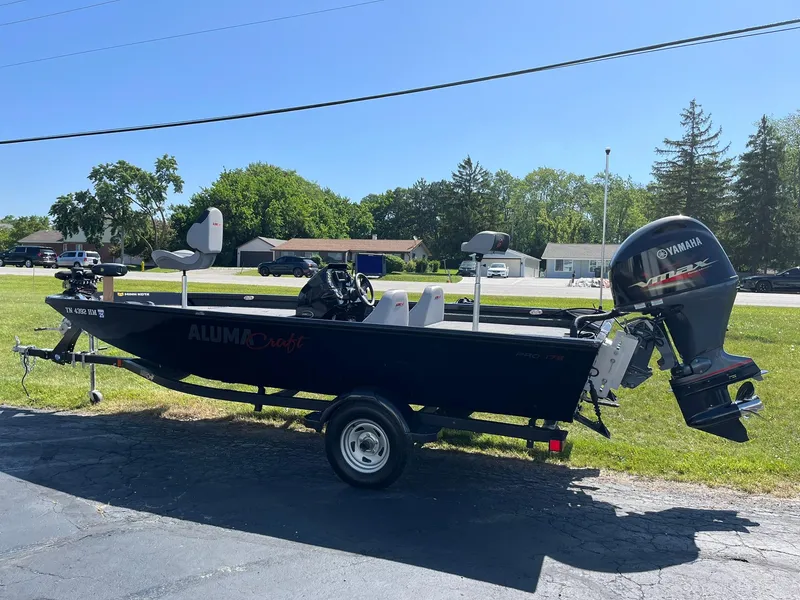 Slide: The Image of 2022 Alumacraft Pro 175 boat with Yamaha motor on a trailer, parked outdoors. - 3