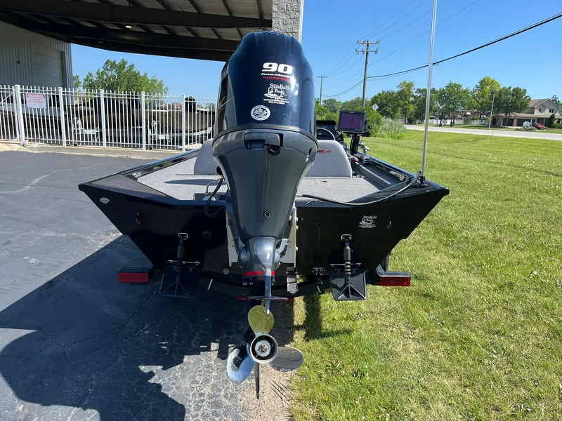 Slide: The Image of 2022 Alumacraft Pro 175 boat with 90 HP outboard motor, parked outdoors. - 4