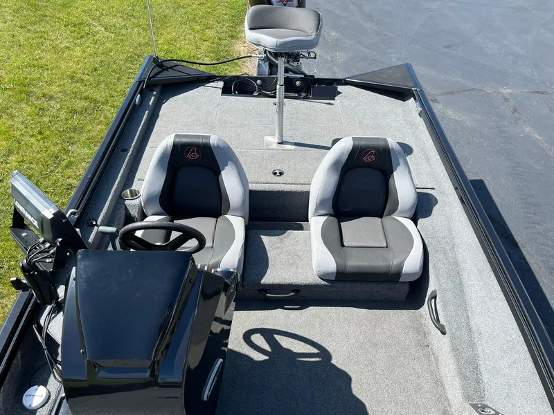 Slide: The Image of 2022 Alumacraft Pro 175 boat interior with dual seats and steering console. - 6