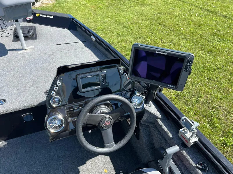 Slide: The Image of 2022 Alumacraft Pro 175 boat dashboard with steering wheel and Lowrance HDS12 display. - 8