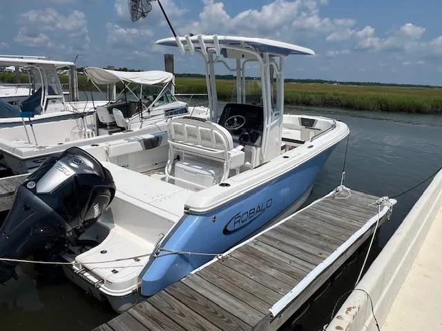 The Image of 2022 Robalo R230 Center Console boat docked, featuring sleek design and powerful engine. - 0