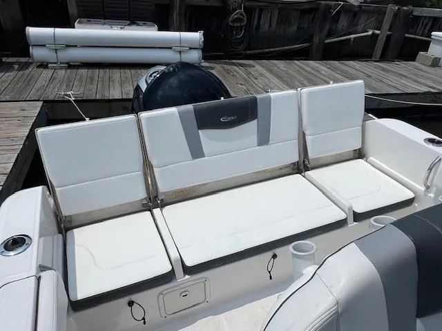 Slide: The Image of 2022 Robalo R230 Center Console boat seating area at dock. - 10