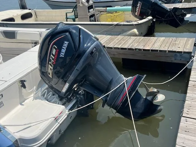 Slide: The Image of 2022 Robalo R230 Center Console with Yamaha outboard motor docked at marina. - 12