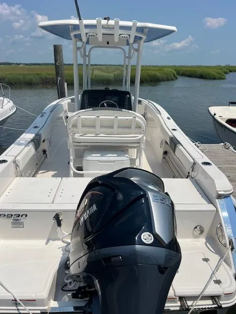 Slide: The Image of 2022 Robalo R230 Center Console boat docked, featuring Yamaha outboard motor, clear sky, and marshland backdrop. - 17