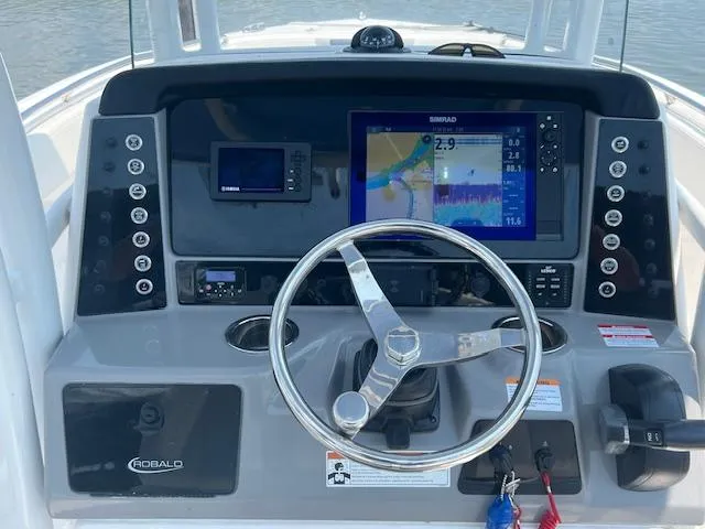 Slide: The Image of 2022 Robalo R230 Center Console dashboard with navigation screens and steering wheel. - 5