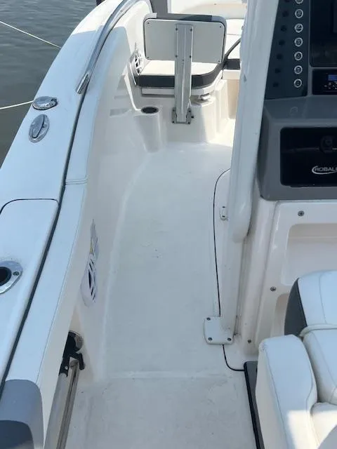 Slide: The Image of 2022 Robalo R230 Center Console boat interior with seating and control panel. - 7