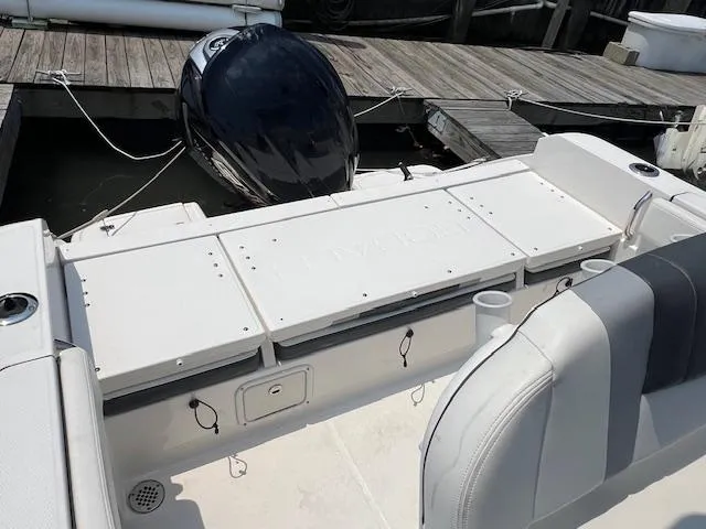 Slide: The Image of 2022 Robalo R230 Center Console boat with outboard motor at dock. - 9