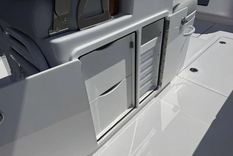 Slide: The Image of 2025 Jupiter 380 LS boat storage compartment with open lid and two white buckets. - 15