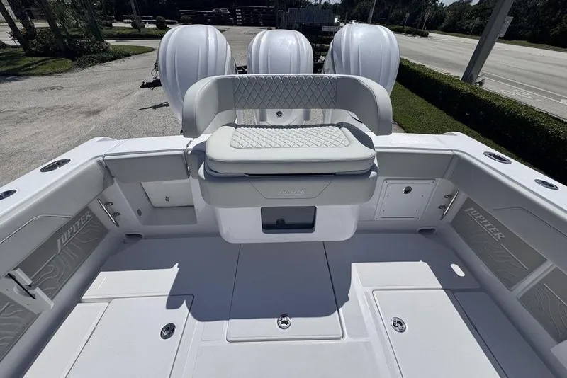 Slide: The Image of 2025 Jupiter 380 LS boat on trailer with triple outboard engines, parked outdoors. - 3